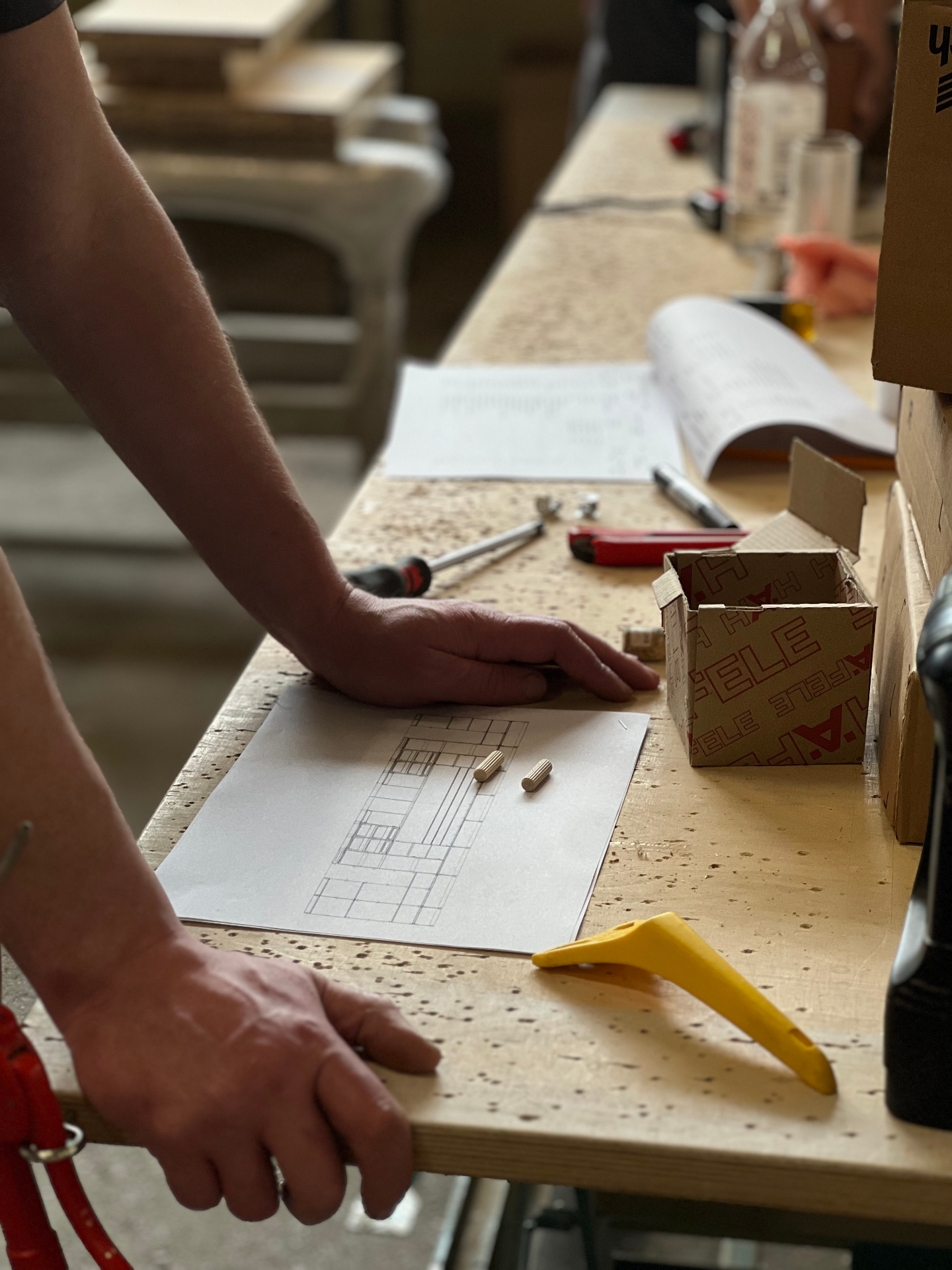 Craftsman working on tambour components